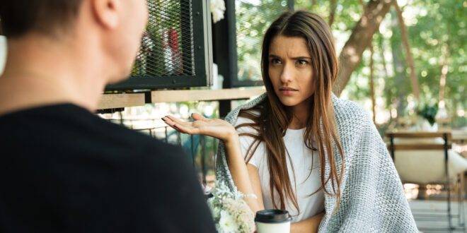 confused young woman gesturing with hand